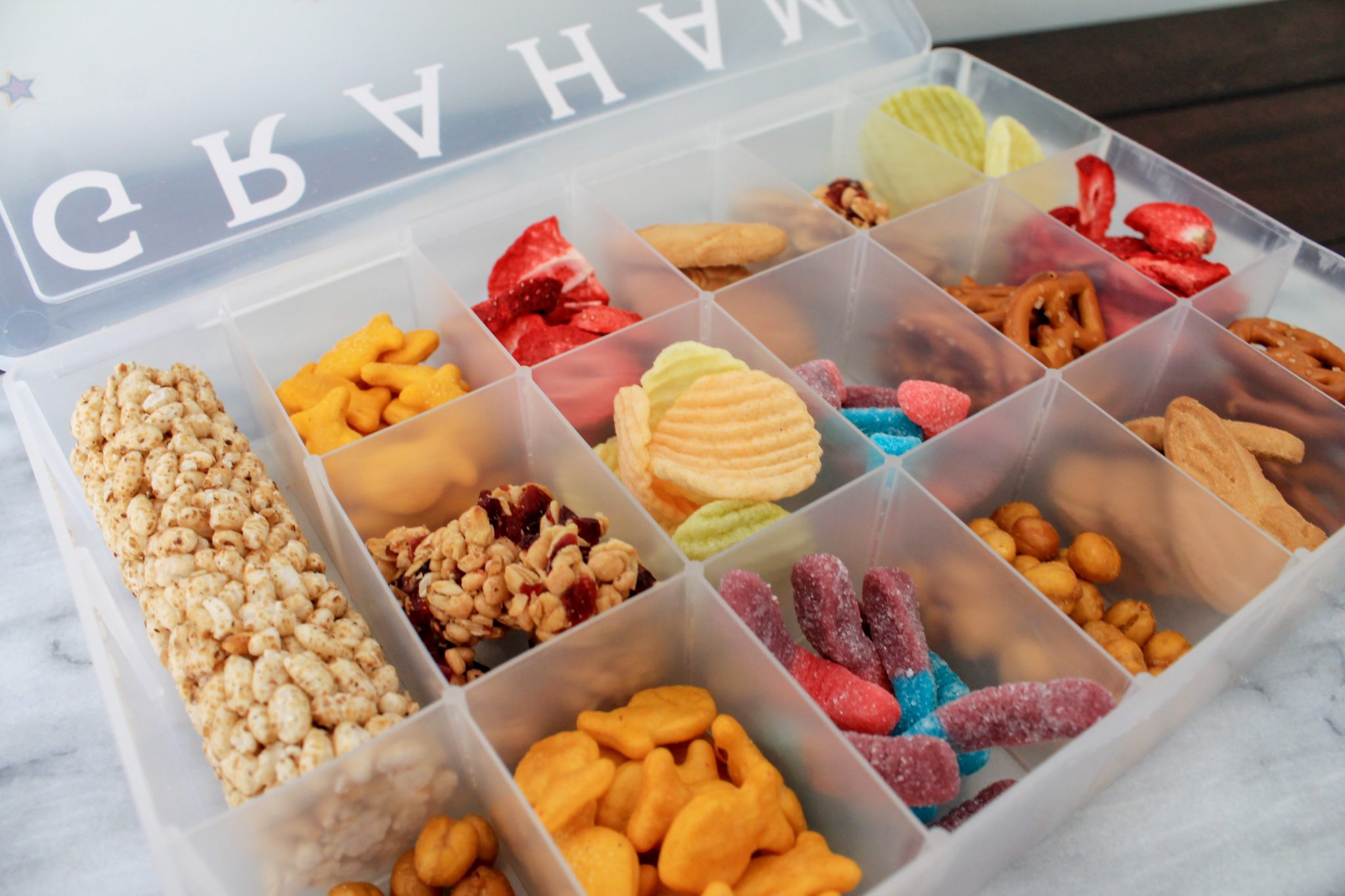 DIY Travel Snack Box for Kids | sunshineandholly.com | personalized Disney tackle box snacks for road-trips | road trips | tips for road trips with kids | family vacation | mickey mouse